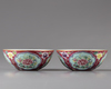 A pair of Chinese ruby-ground famille rose 'floral' bowls