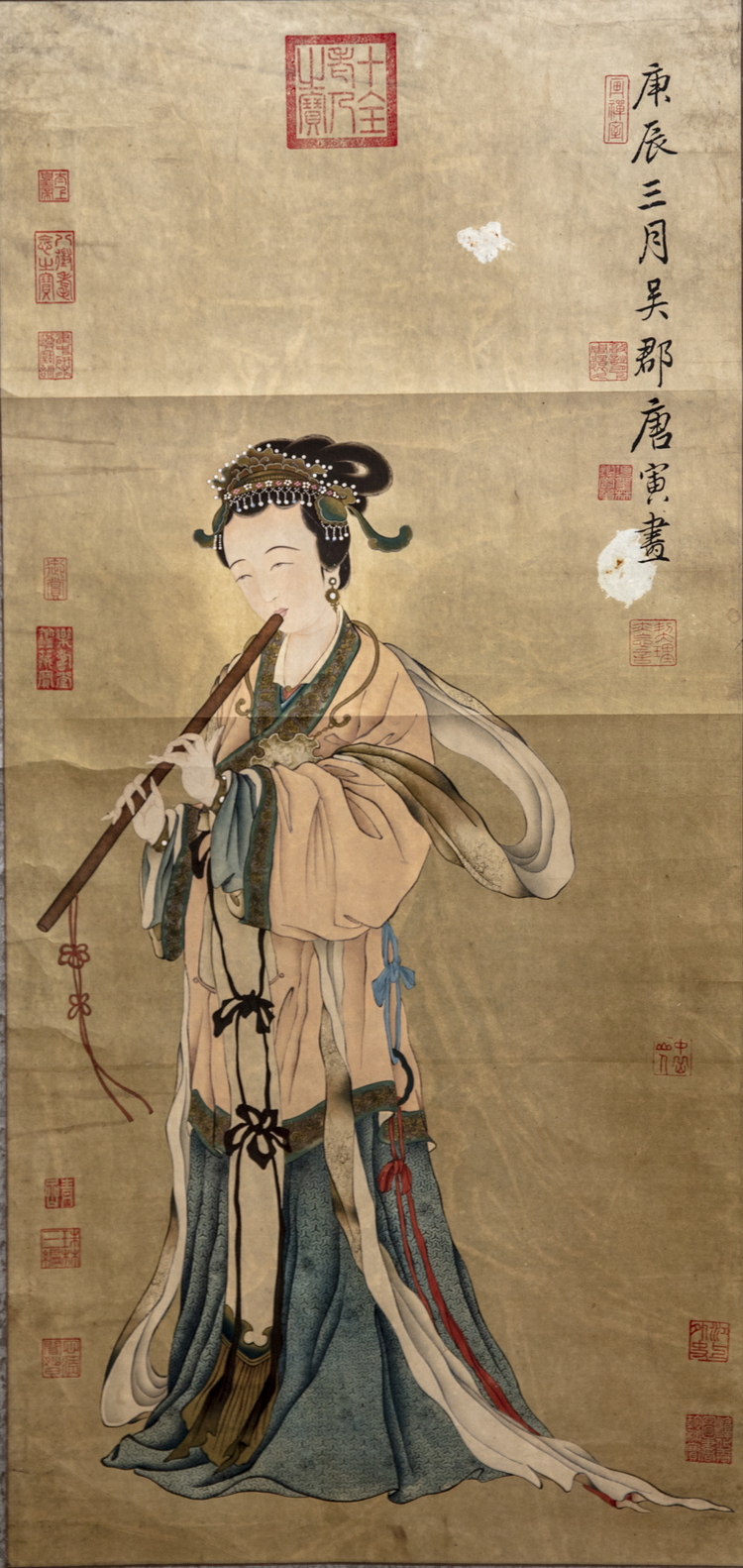 A Chinese hand scroll depicting a lady playing the flute
