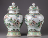 A pair of famille verte vases with cover