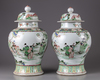 A pair of famille verte vases with cover