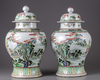 A pair of famille verte vases with cover