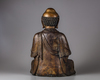 A Chinese parcel-gilt bronze figure of a monk