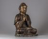 A Chinese parcel-gilt bronze figure of a monk