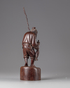 A Chinese hardwood carving of a fisherman
