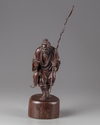 A Chinese hardwood carving of a fisherman