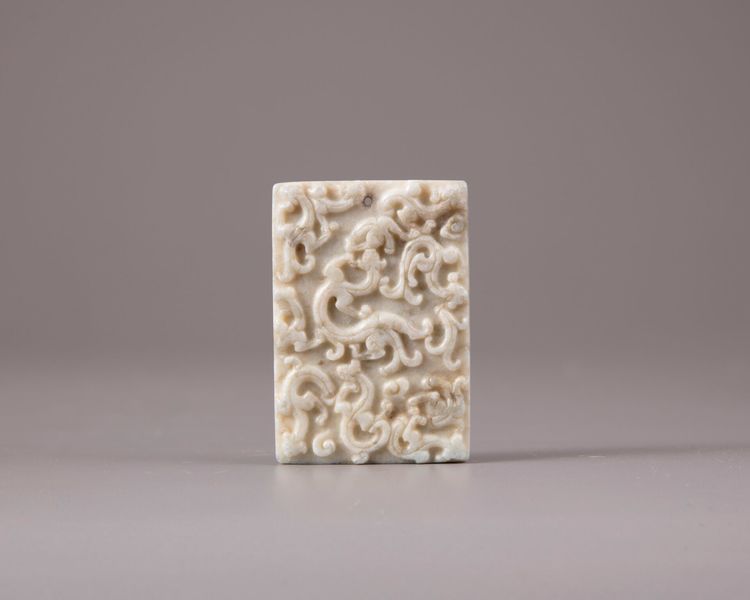A Chinese white and grey jade plaque