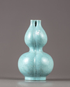 A Chinese celadon-ground white-enamel-decorated conjoined triple-neck double-gourd vase