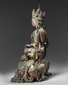 A bronze figure of guanyin seated on a mythical beast