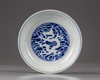 A Chinese blue and white reserve-decorated ‘dragon’ dish