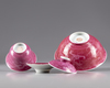 Two rose glazed bowls with a cover and a stand