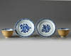 Two pairs of Chinese café-au-lait-ground blue and white cups and saucers