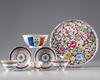 A Chinese famille rose group of three cups, two saucers, a bowl and a dish