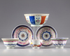 A Chinese famille rose group of three cups, two saucers, a bowl and a dish