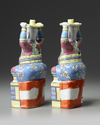 A PAIR OF CHINESE FAMILLE ROSE FOREIGNER CANDLESTICKS, 19TH CENTURY