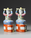 A PAIR OF CHINESE FAMILLE ROSE FOREIGNER CANDLESTICKS, 19TH CENTURY