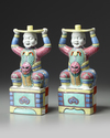 A PAIR OF CHINESE FAMILLE ROSE FOREIGNER CANDLESTICKS, 19TH CENTURY