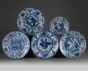 Four Chinese blue and white 'Kraak porcelain' chargers and a bowl