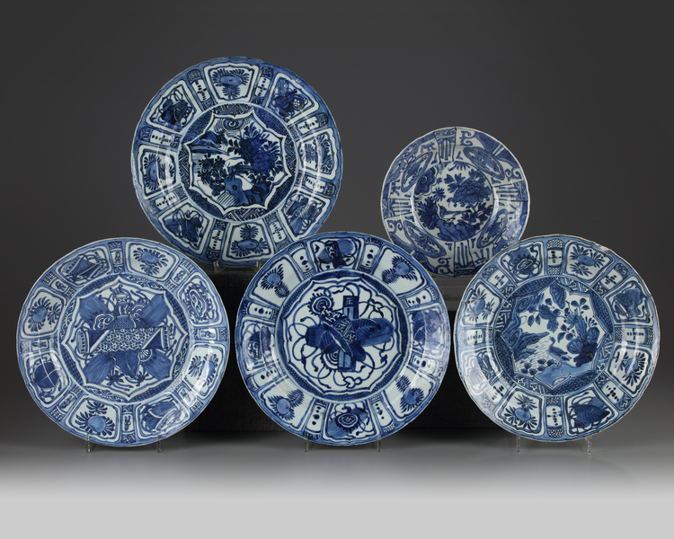 Four Chinese blue and white 'Kraak porcelain' chargers and a bowl