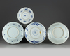 Four Chinese blue and white foliate-rimmed 'scholar landscape' dishes