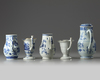 A GROUP OF FIVE CHINESE BLUE AND WHITE AND EN GRISAILLE POURING VESSELS