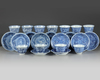 A set and a matched set of Chinese blue and white ‘flower scroll’ cups and saucers