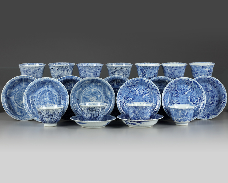 A set and a matched set of Chinese blue and white ‘flower scroll’ cups and saucers