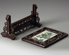 A Chinese famille verte plaque inset into a wooden table screen