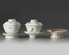 Two Chinese cups, covers, and saucers and a stem dish