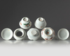 Two Chinese cups, covers, and saucers and a stem dish