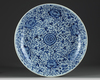 A LARGE CHINESE BLUE AND WHITE 'SCROLLING PEONY' CHARGER, KANGXI PERIOD (1662-1722)