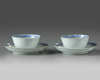 A pair of Chinese bianco sopra bianco-decorated cups and saucers