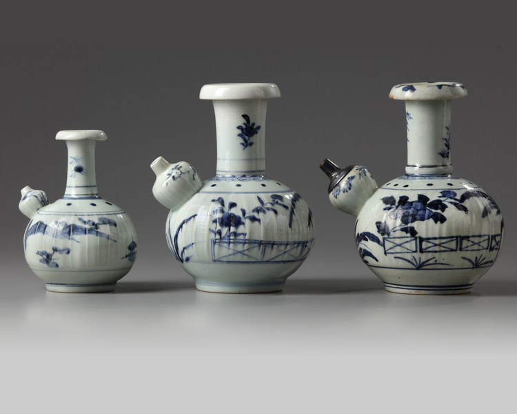 A group of three blue and white Arita kendi's