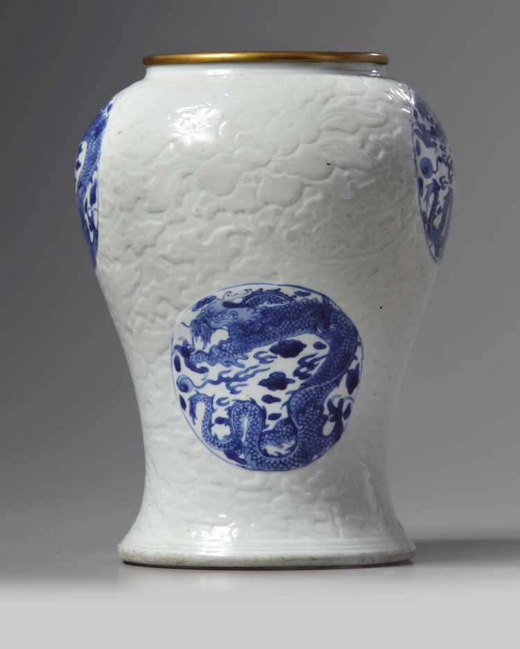 A rare Chinese moulded white-ground blue and white 'dragon' vase