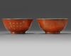 A pair of Chinese coral-ground gilt-decorated bowls
