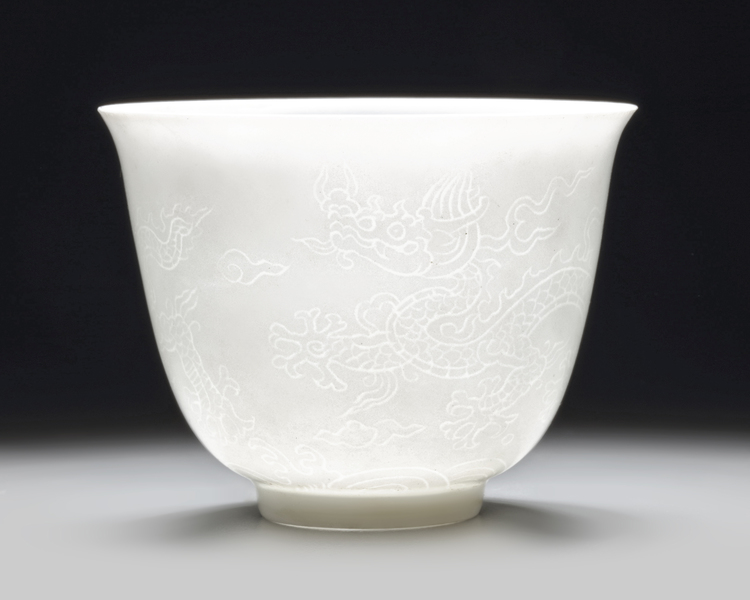 A small Chinese white-glazed anhua-decorated 'dragon' cup