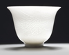 A Chinese white-glazed 'phoenix' cup