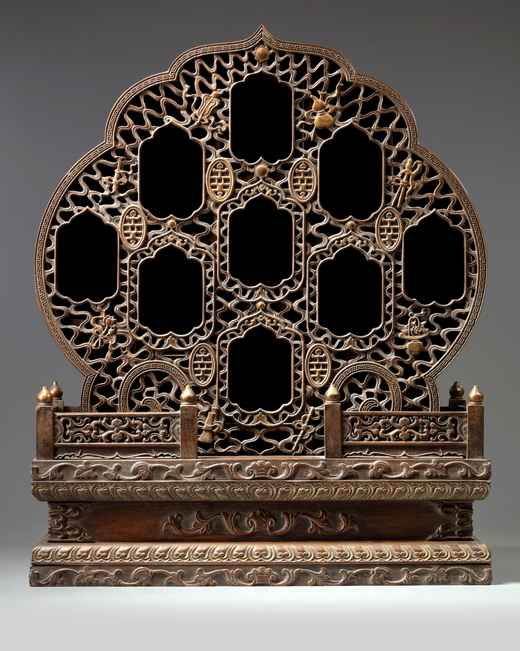 A Chinese hardwood parcel-gilt foliate altar cabinet
