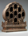 A Chinese hardwood parcel-gilt foliate altar cabinet