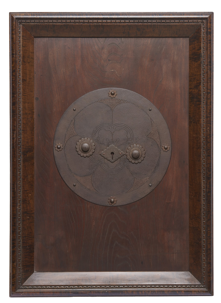 A large Japanese decorative metal key-plate of a door.