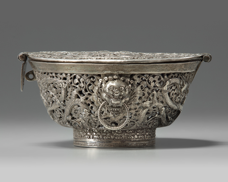 A Tibetan silver tea bowl container and hinged cover