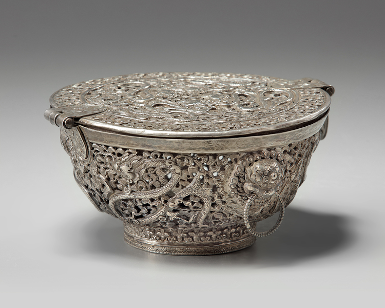 A Tibetan silver tea bowl container and hinged cover
