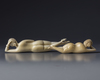 Two Chinese carved ivory reclining figures