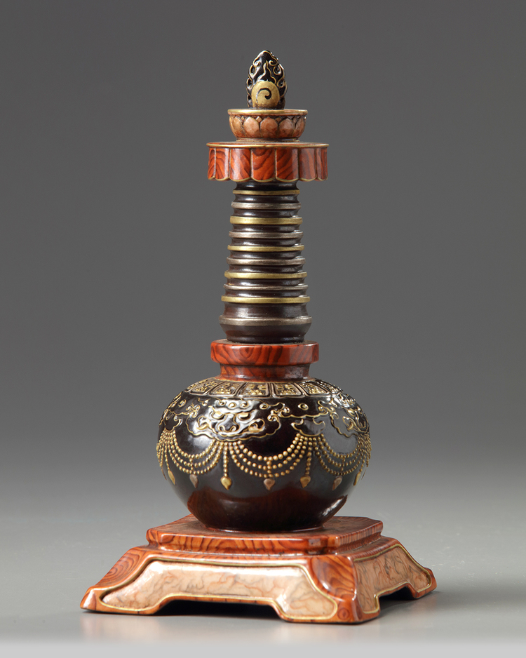 A Chinese imitation bronze and faux-bois decorated stupa