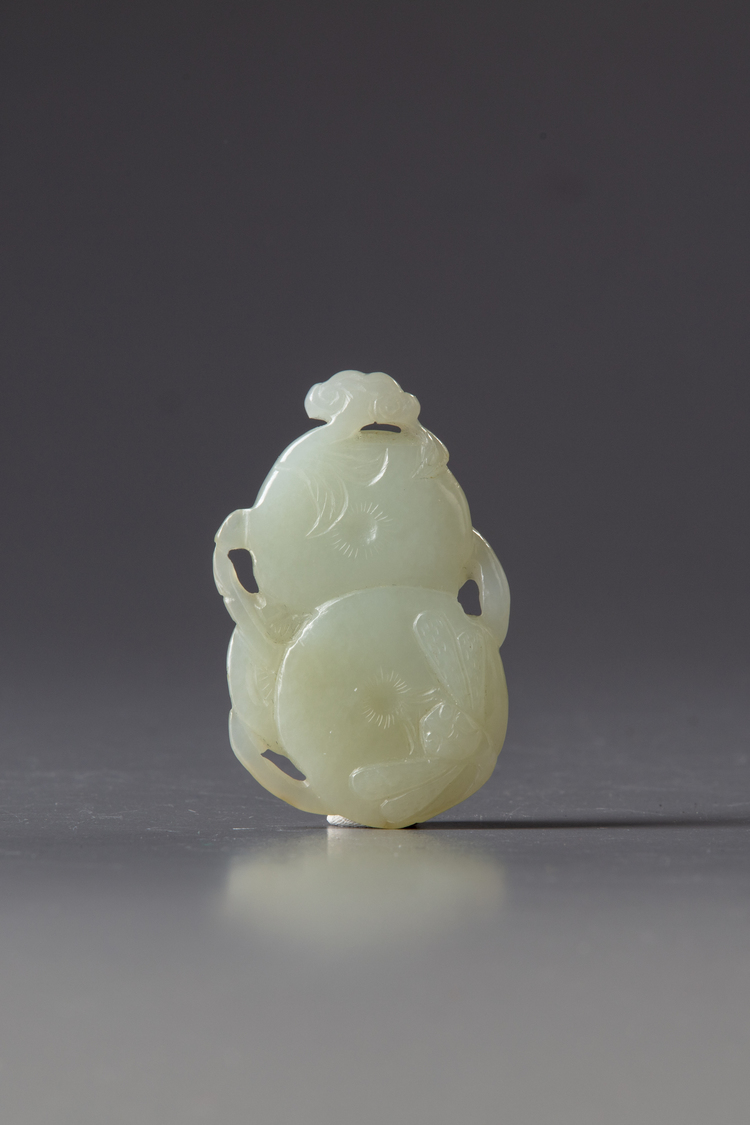 A CHINESE WHITE JADE 'PERSIMMON AND DRAGONFLY' CARVING