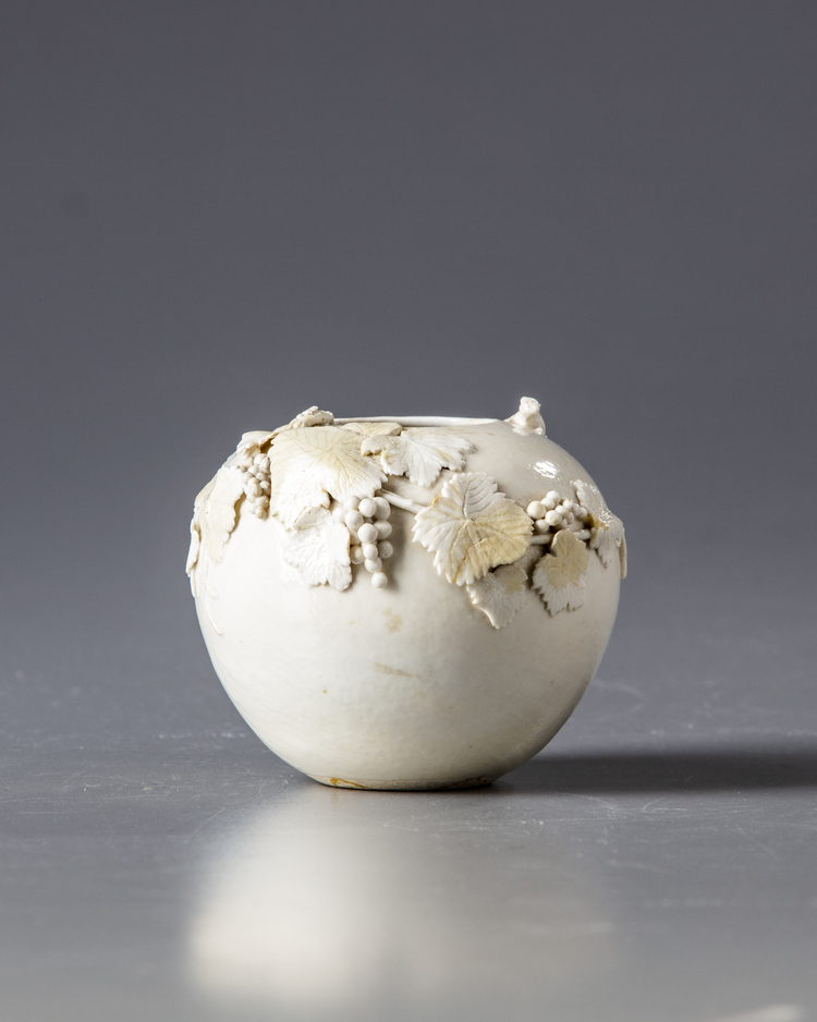 A CHINESE WHITE-GLAZED 'SQUIRREL AND GRAPES' WATER POT