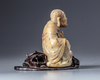 A Chinese soapstone  figure with a zitan wooden stand