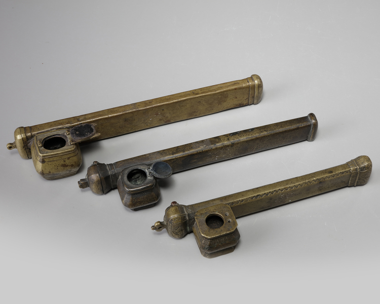 Three Armenian copper pen holders and inkwells