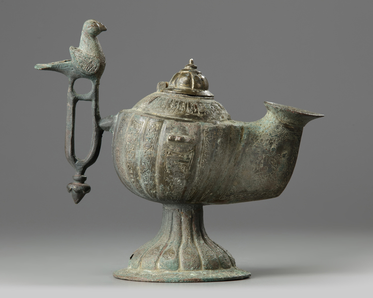 An Islamic bronze oil lamp