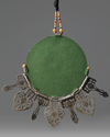 An Islamic gilt and silver inlaid pendant