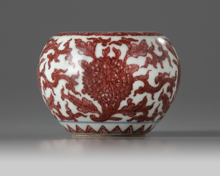 A Chinese underglaze copper-red and blue-decorated 'floral' washer, pingguo zun